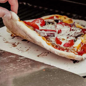 Round 30.5 cm cordierite pizza stone in creamy white, perfect for baking crispy pizzas, bread, and cheese with excellent heat retention.