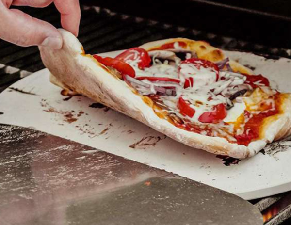 Round 30.5 cm cordierite pizza stone in creamy white, perfect for baking crispy pizzas, bread, and cheese with excellent heat retention.